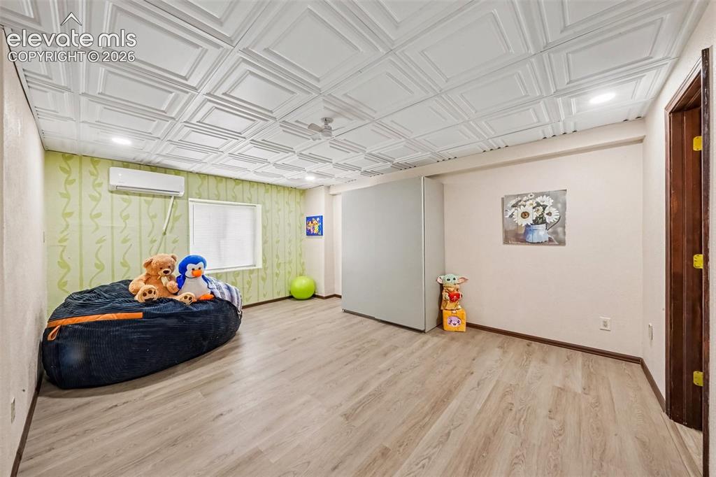 Image 22 of 44: Spacious basement bedroom featuring durable LVT flooring and convenient acc