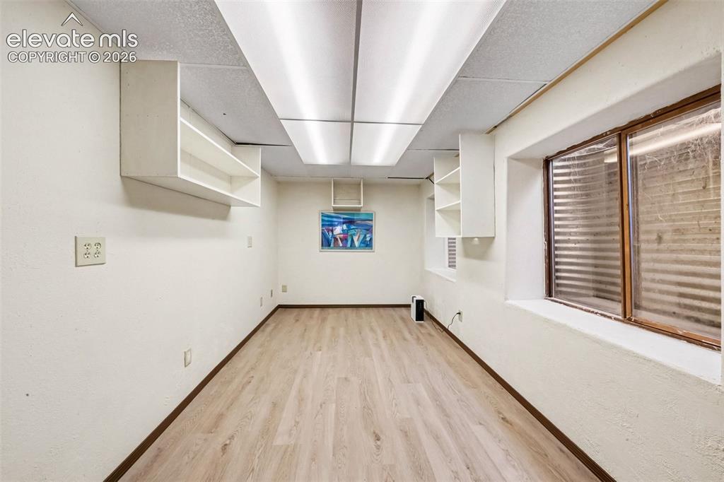 Image 25 of 44: Bonus basement room featuring LVT flooring and flexible space for guests,