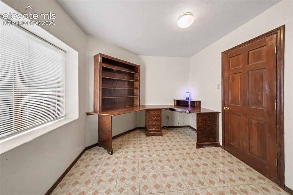 Image 26 of 44: Versatile basement office offers a quiet space for working from home, study