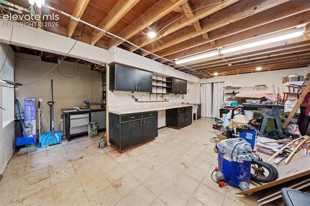 Image 28 of 44: Large basement workshop offers generous space for projects, hobbies, tools,