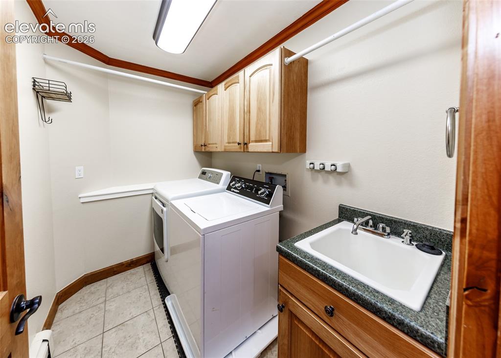 Image 34 of 50: Laundry room main level with a sink