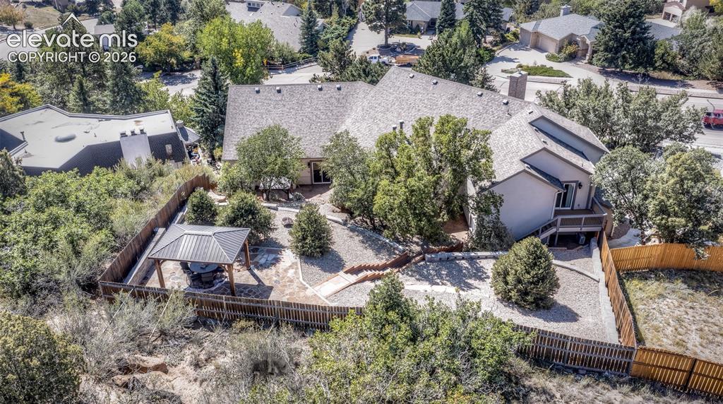 Image 4 of 50: Top Back area of the home from the drone up above with the pergola and 6 ch