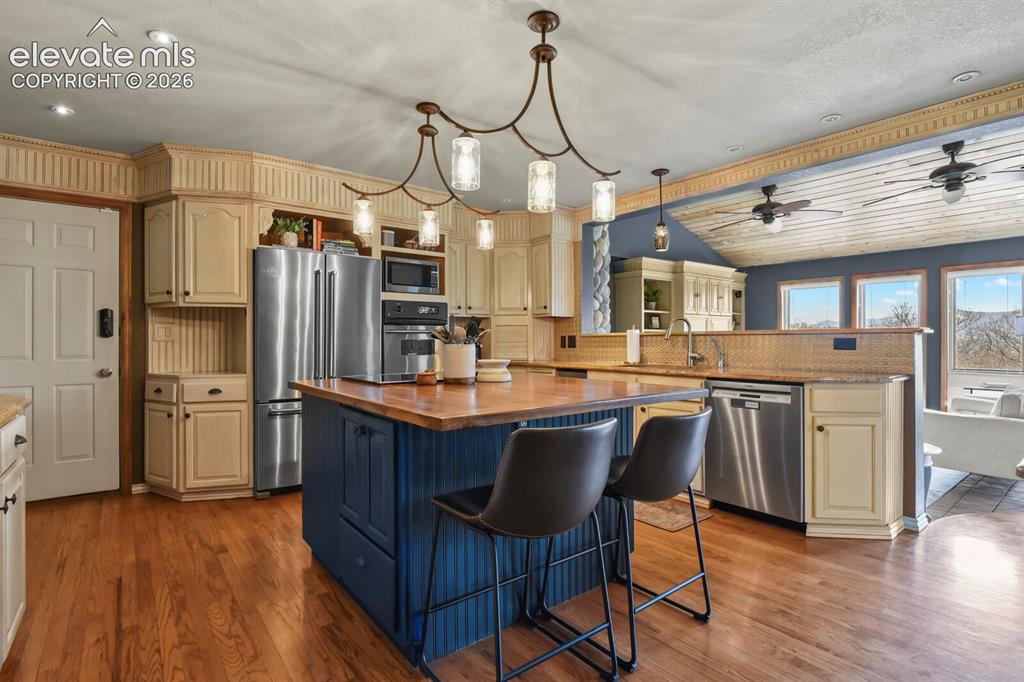 Image 11 of 41: Spacious, well-appointed kitchen with rich cabinetry and great flow for eve