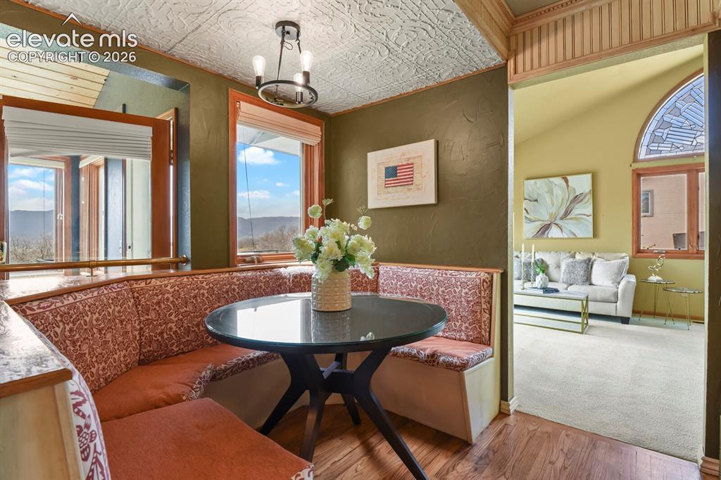 Image 13 of 41: Charming breakfast nook with built-in seating, abundant natural light, and 