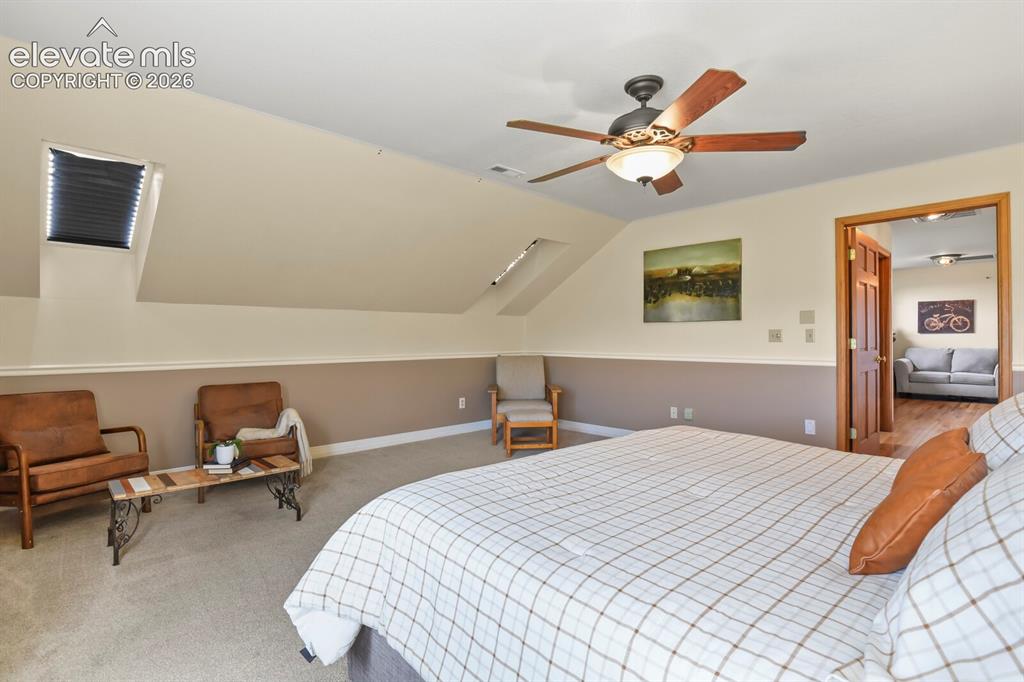 Image 21 of 41: Bright and spacious primary bedroom with room to relax.