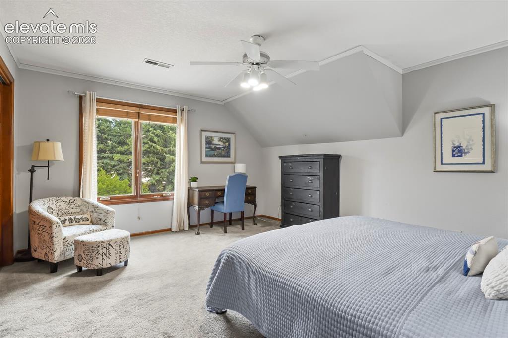 Image 25 of 41: Spacious secondary bedroom with large window, and flexible space for a desk