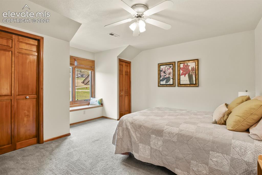 Image 26 of 41: Bright secondary bedroom with a charming window nook, and ample closet spac