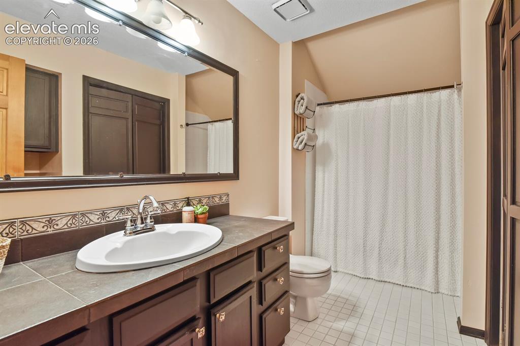 Image 29 of 41: Spacious upper-level full bath with large vanity, ample storage, and tub/sh