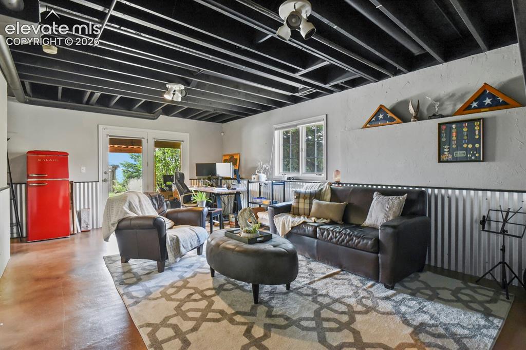 Image 30 of 41: Spacious lower-level recreation room—perfect for a second living area, medi