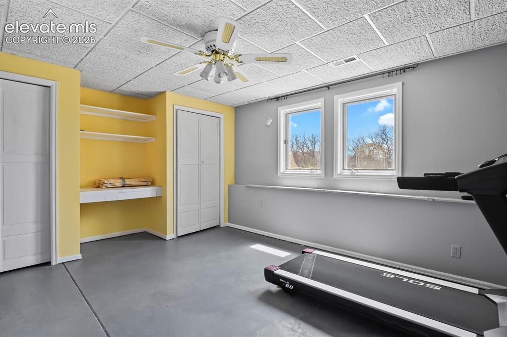 Image 31 of 41: Spacious lower-level bedroom with abundant natural light, built-in storage,