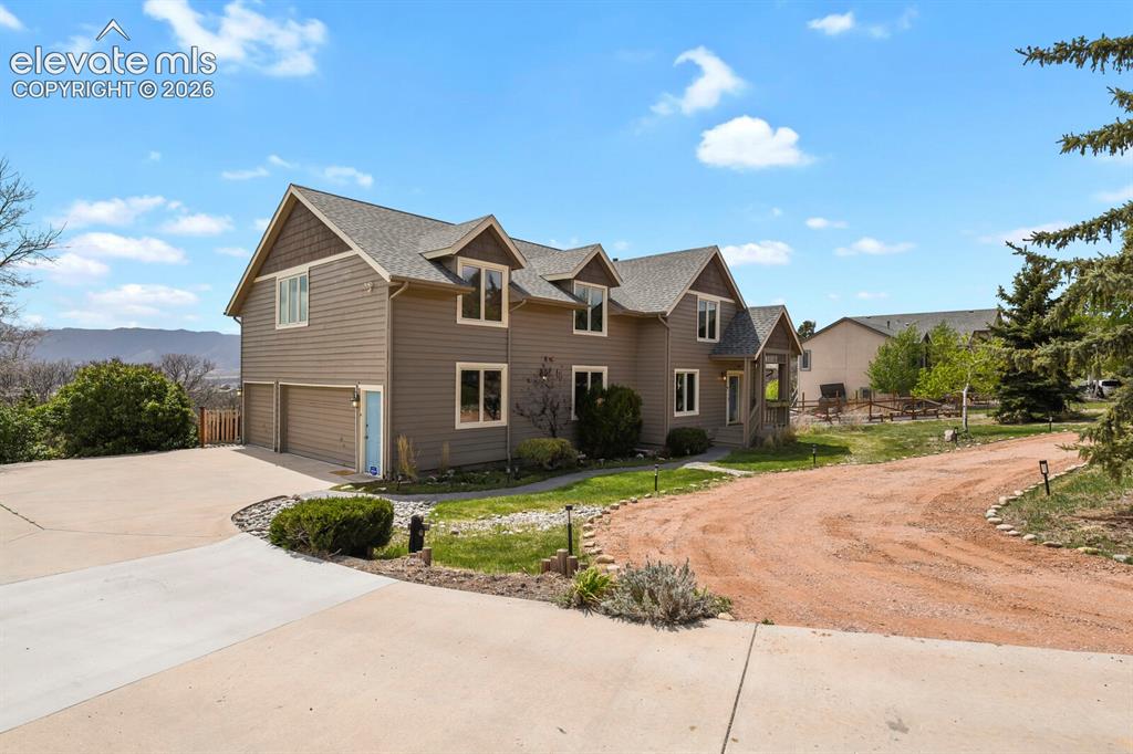 Image 37 of 41: Striking front elevation with balanced architecture, gabled rooflines, and 