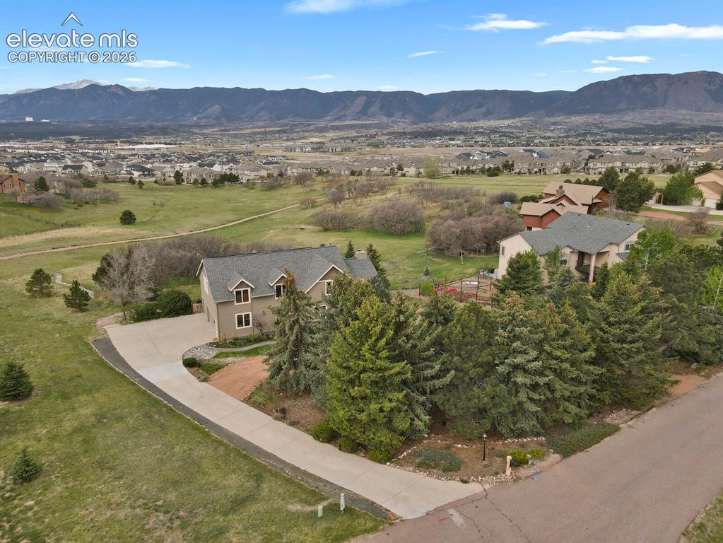 Image 4 of 41: Aerial view showcasing the home’s setting with expansive Front Range mounta