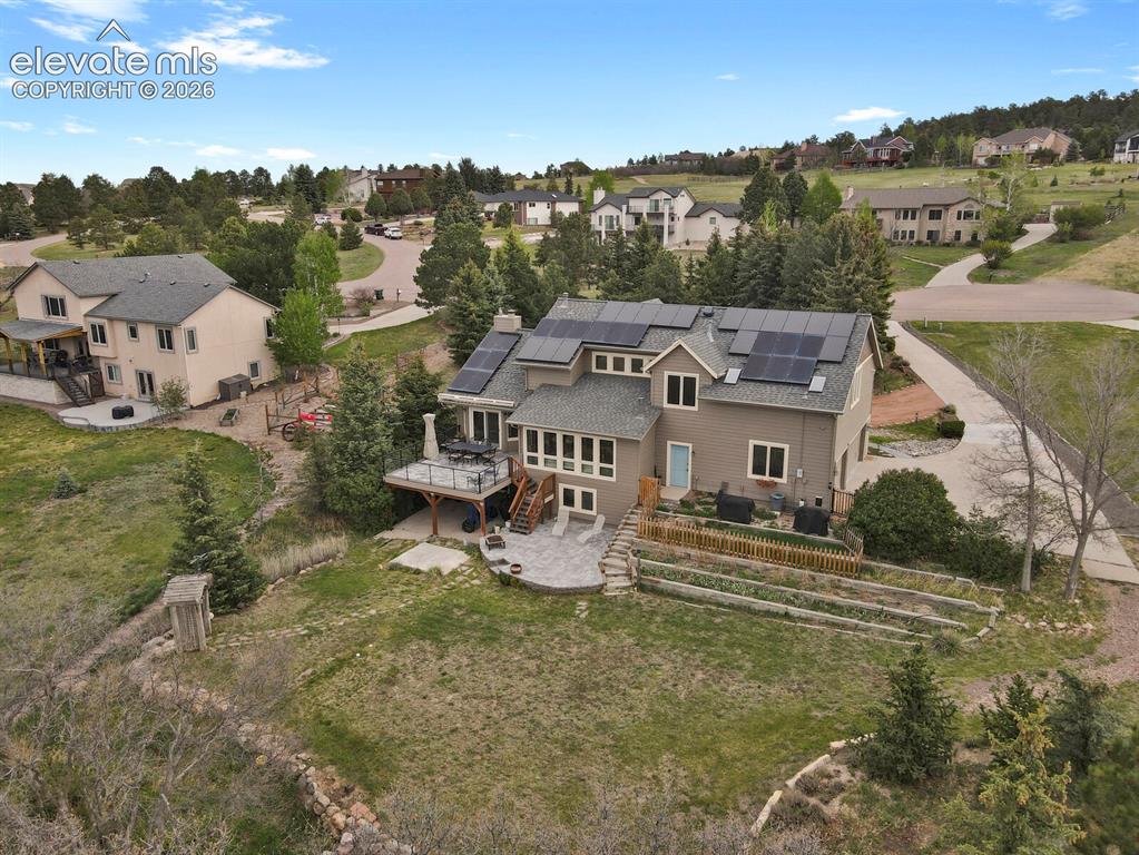 Image 7 of 41: Aerial view showcasing the home’s rear elevation, including the upper deck,