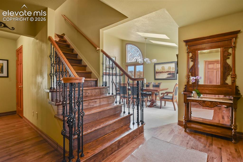 Image 8 of 41: Welcoming entry with rich hardwood floors, a beautifully crafted staircase,