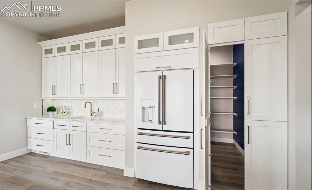 Image 11 of 50: Hidden walk-in butler pantry. 