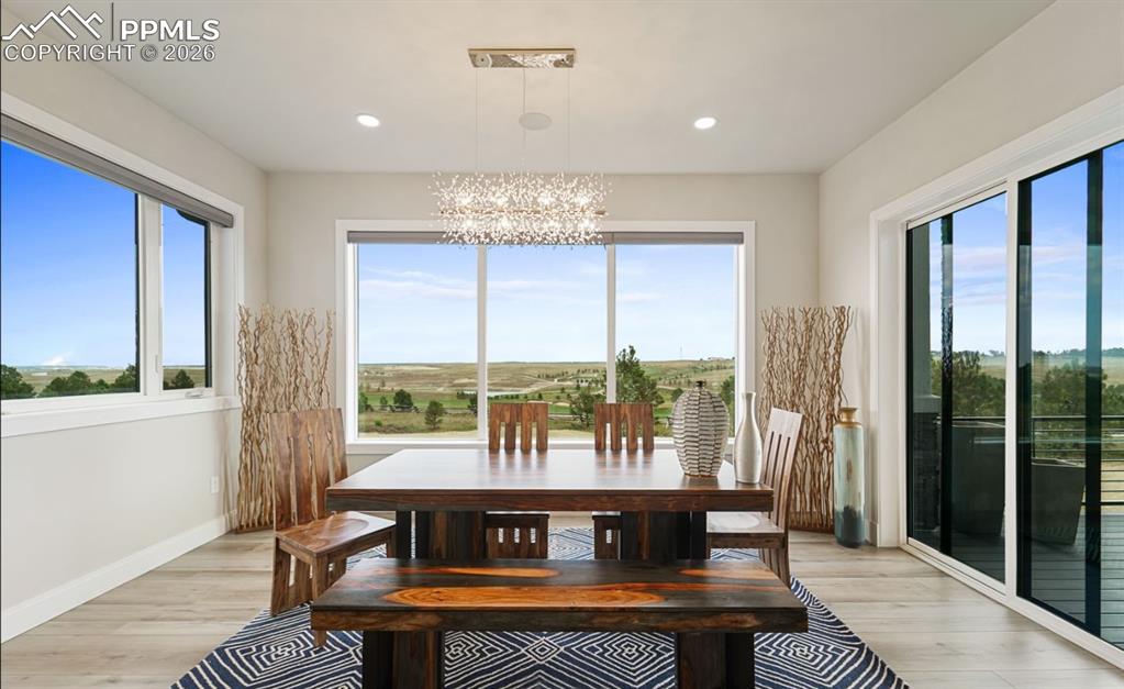 Image 13 of 50: Electric blinds, another walk-out to the wrapping deck and covered outdoor 