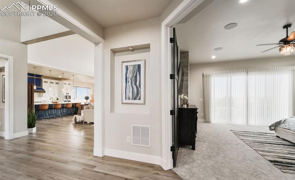 Image 16 of 50: Through the French doors, the primary suite is an oasis of it