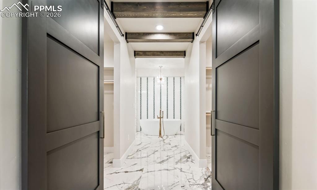 Image 19 of 50: Dual closets entering the private bathroom.