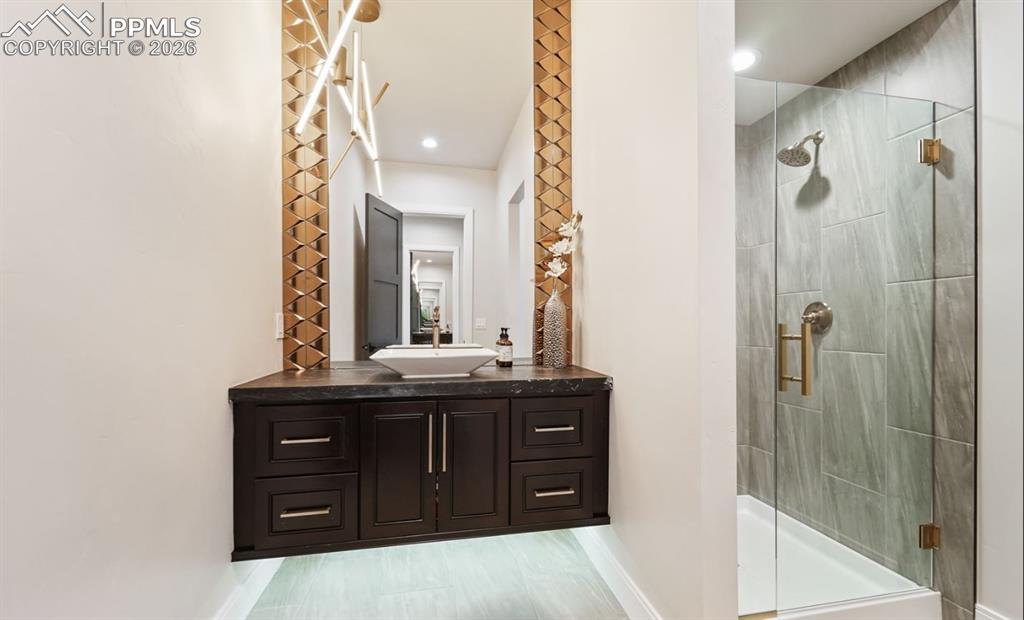 Image 24 of 50: Perfectly placed between the nursery and living room, this 3/4 bathroom is 