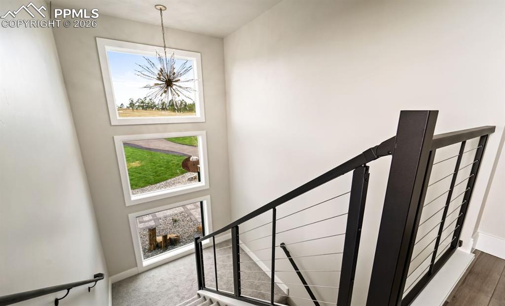Image 26 of 50: The landing to this dedicated access to the rooftop deck offers a mini frid