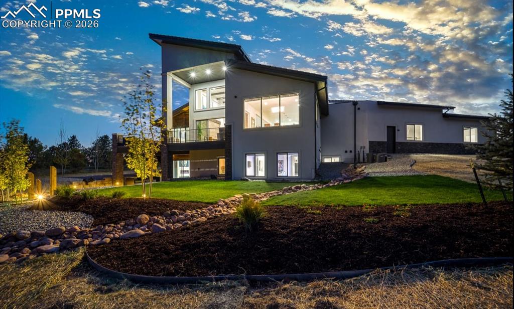 Image 49 of 50: Stunning lighting features around the home showcase this home, day or night