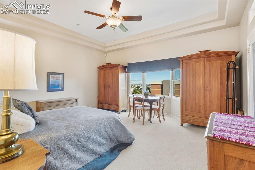 Image 21 of 50: Large bedroom with sitting area and walk-out