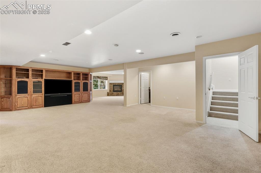 Image 31 of 50: 1 of 2 downstairs Family Rooms