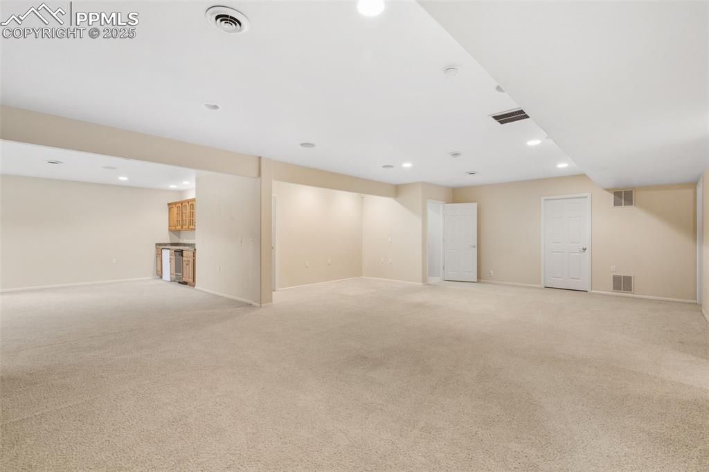 Image 33 of 50: lOOKING FROM 1 FAMILY ROOM INTO THE 2ND FAMILY ROOM DOWNSTAIRS