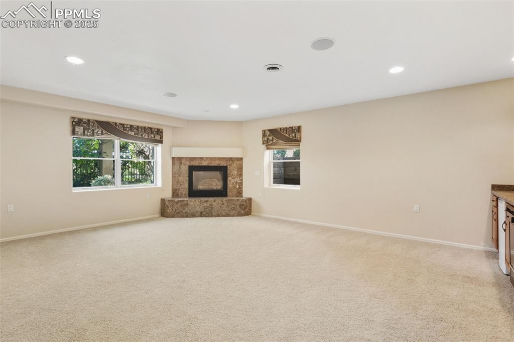 Image 35 of 50: Family Room 2 of 2 downstairs.  Fireplace and Wet bar kitchenette