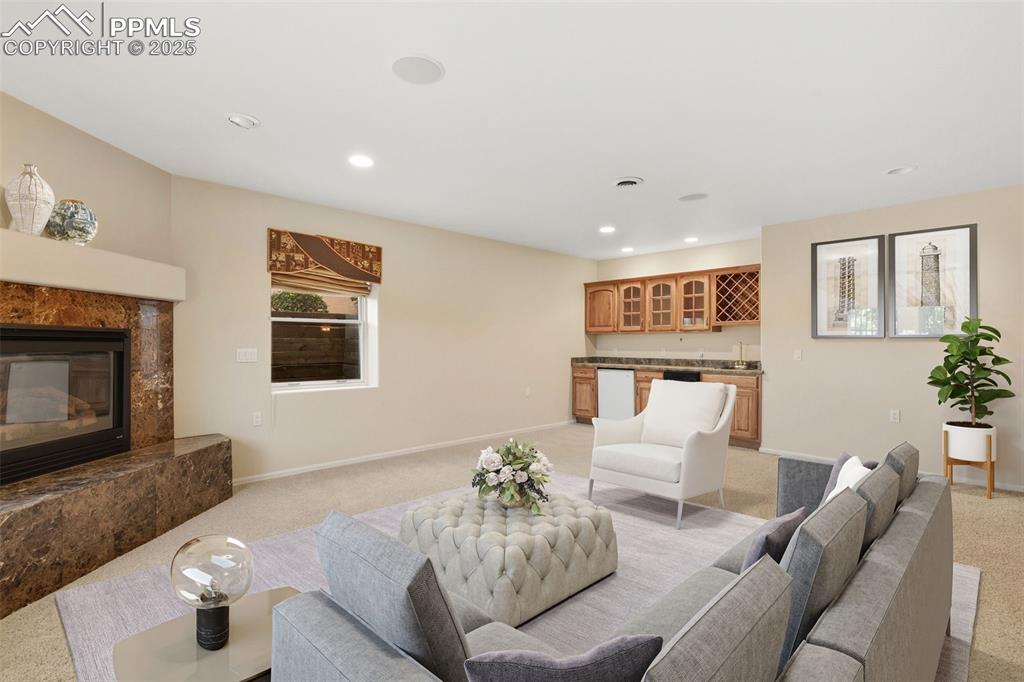 Image 38 of 50: VIRTUAL STAGED FAMILY ROOM 2 of 2 with fireplace and kitchenette