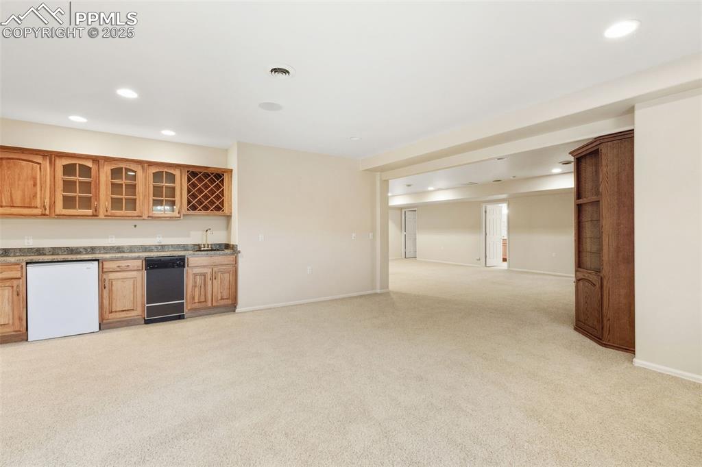 Image 39 of 50: Family Room 2 of 2 Downstairs with Wet bar kitchenette