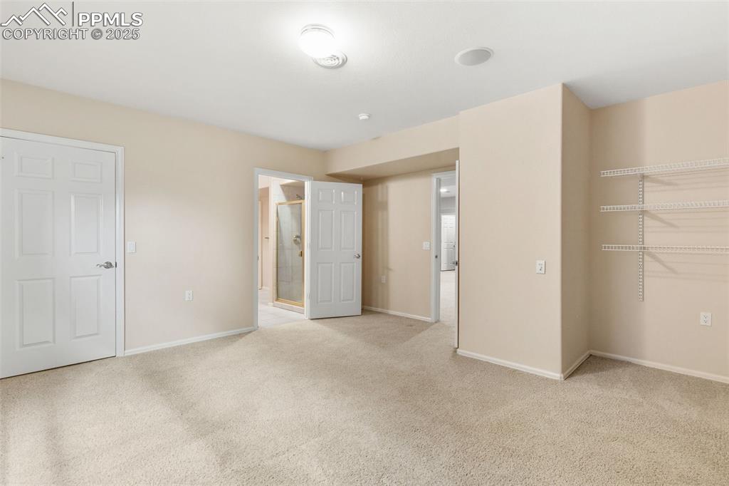 Image 45 of 50: Downstairs bedroom looking towards bath which is between the 2 bedrooms