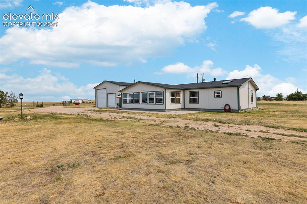 Image 2 of 45: Expansive property featuring a single-story residence with a multi-pane win