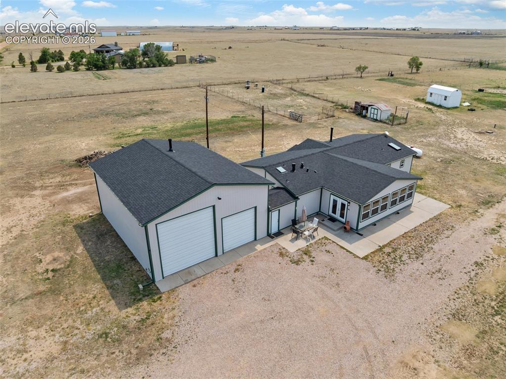 Image 5 of 45: Expansive property featuring a detached two-car garage with white overhead