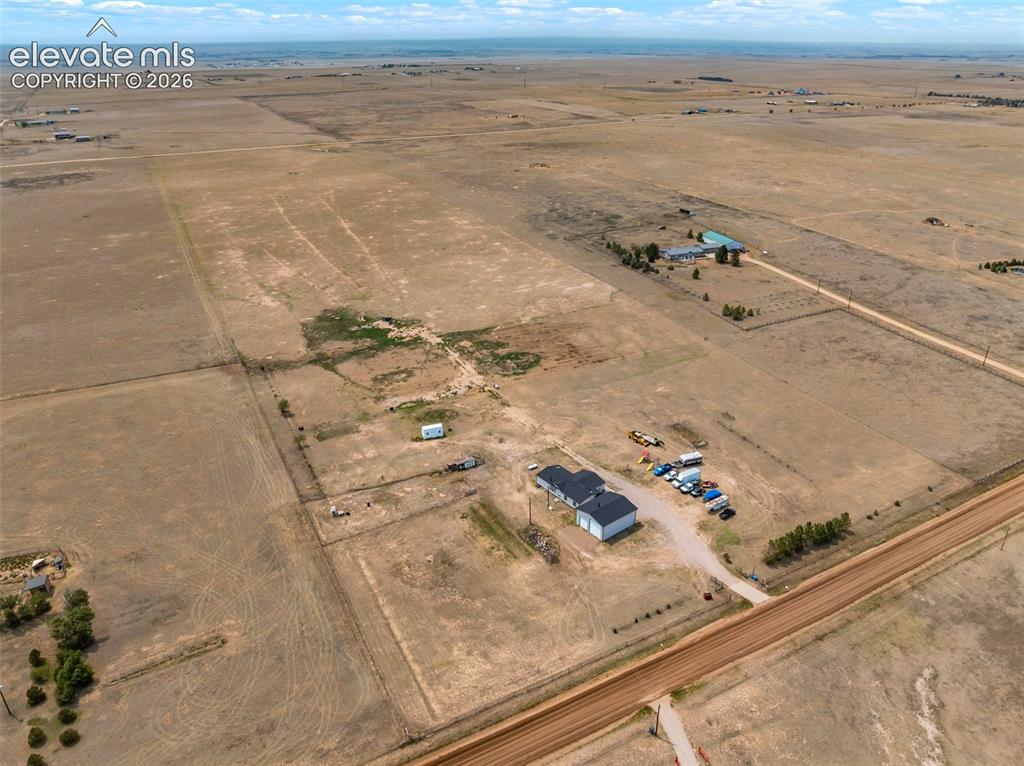 Image 6 of 45: Expansive rural property featuring multiple structures, including a two-sto