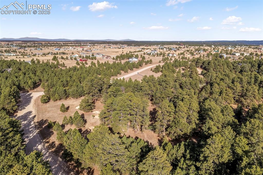Image 3 of 45: Aerial view of property and surrounding area with mountains and a forest