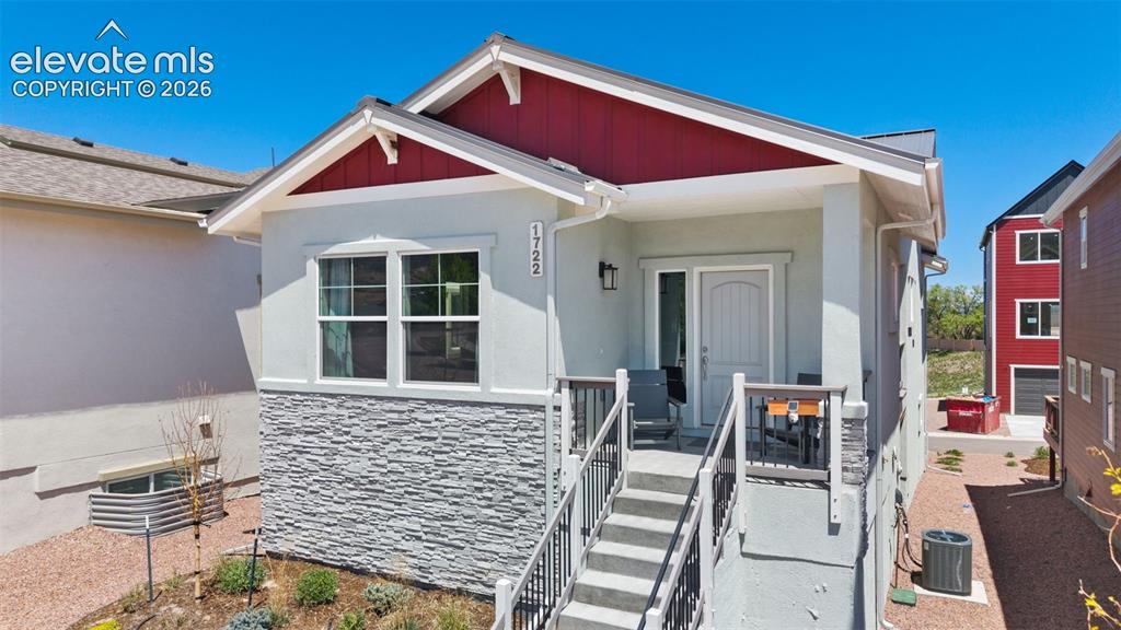 Image 1 of 41: Contemporary home exterior featuring a multi-tone facade with a prominent r