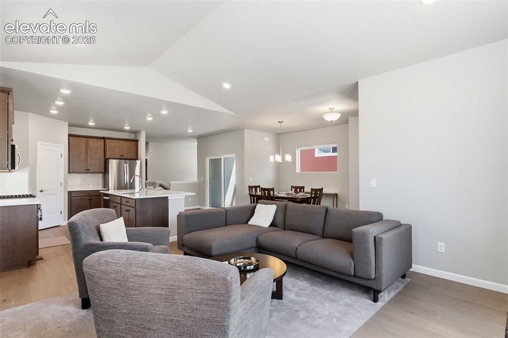 Image 13 of 41: Open-concept living space featuring light-colored flooring, recessed lighti