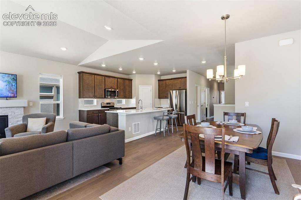 Image 15 of 41: Open-concept living space featuring wood-finish flooring, a kitchen island
