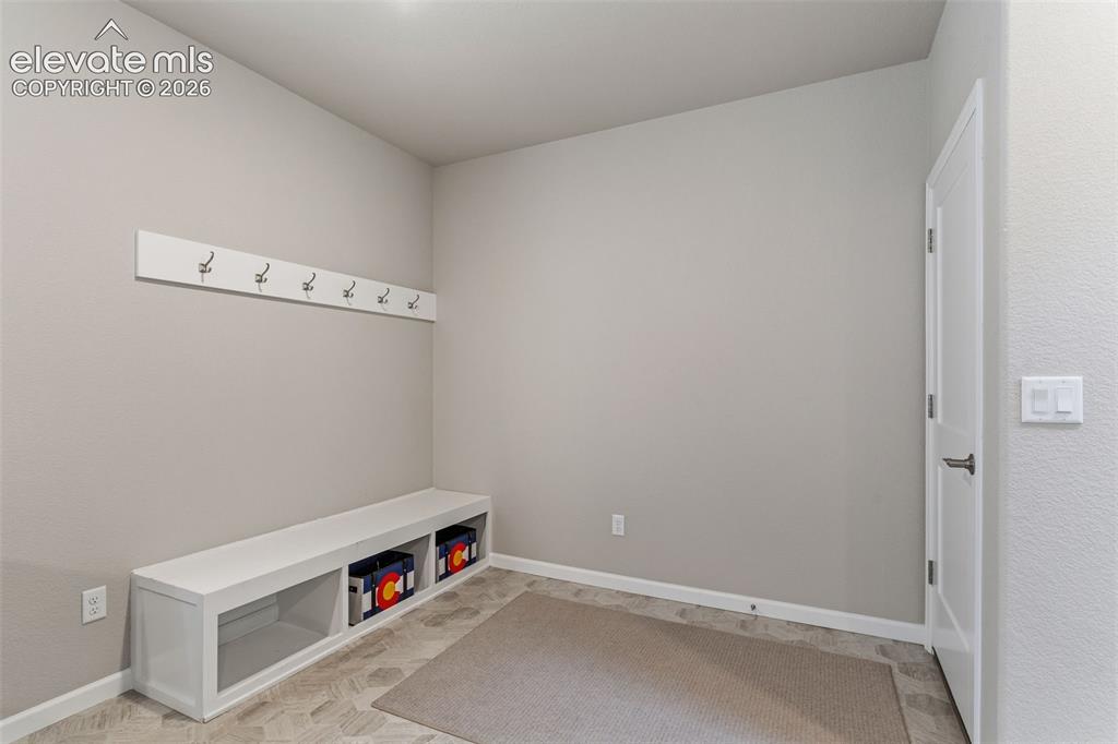 Image 20 of 41: Entryway featuring a built-in bench with storage cubbies and an overhead co