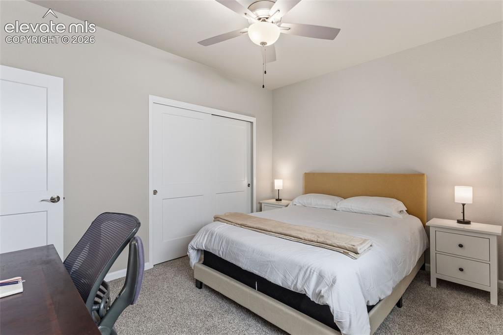 Image 22 of 41: Bedroom featuring light gray wall paint, gray carpet flooring, a ceiling fa