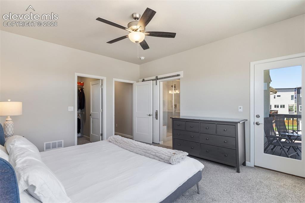 Image 25 of 41: Carpeted room featuring a ceiling fan with integrated lighting, a glass-pan