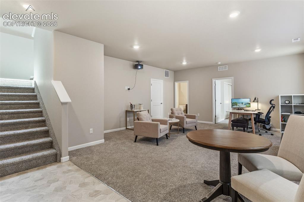 Image 32 of 41: Spacious carpeted room featuring recessed lighting, a built-in projector, a