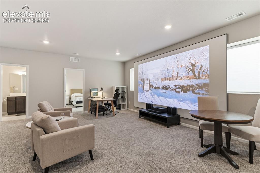 Image 34 of 41: Spacious multi-purpose room featuring a large projection screen, recessed l