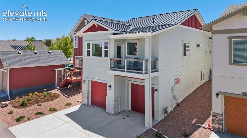 Image 5 of 41: Contemporary exterior with light-colored stucco and red accents, featuring