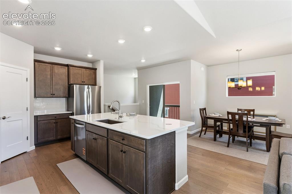Image 8 of 41: Open-concept kitchen and dining area featuring a large center island with a