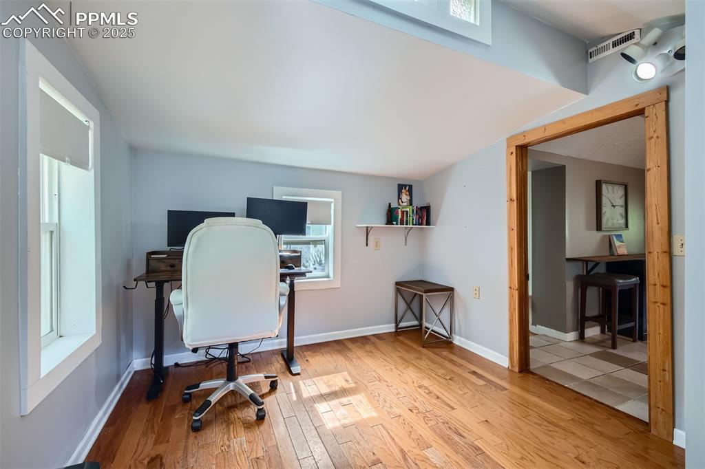 Image 14 of 20: Bedroom featuring wood finished floors and baseboards