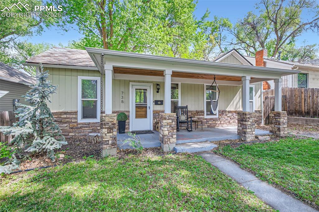 Image 2 of 20: View of front facade with stone siding and a porch