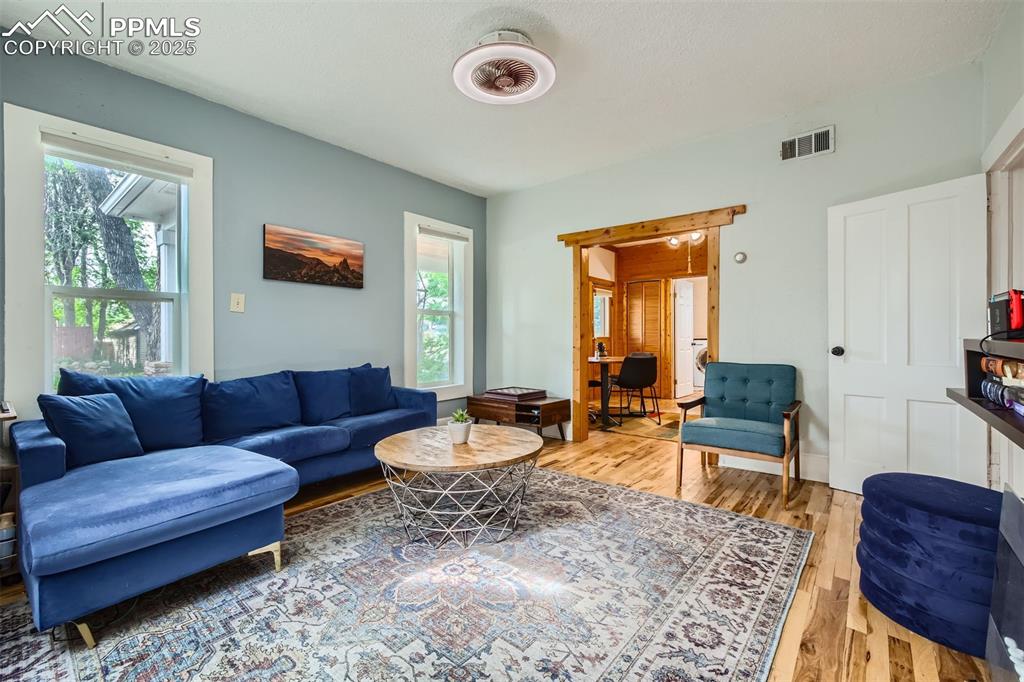 Image 5 of 20: Living area with light wood-style flooring