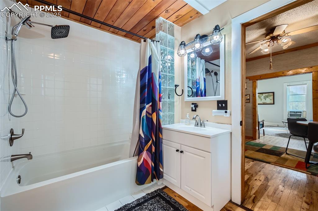 Image 8 of 20: Full bathroom featuring shower / bath combo with shower curtain, vanity, ha